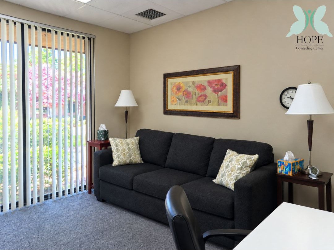 A quieter room with a deep sofa and a desk lamp.