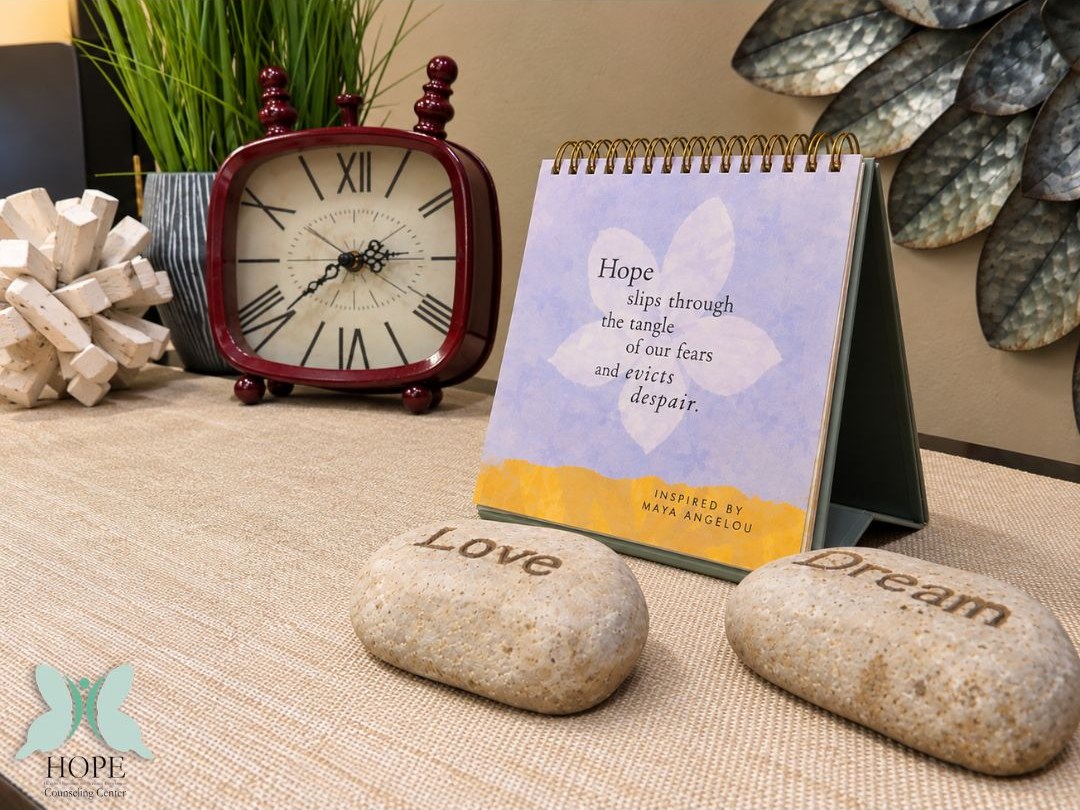 HOPE Counseling Center welcome display with a clock, an inspirational message, and stones labeled Love and Dream